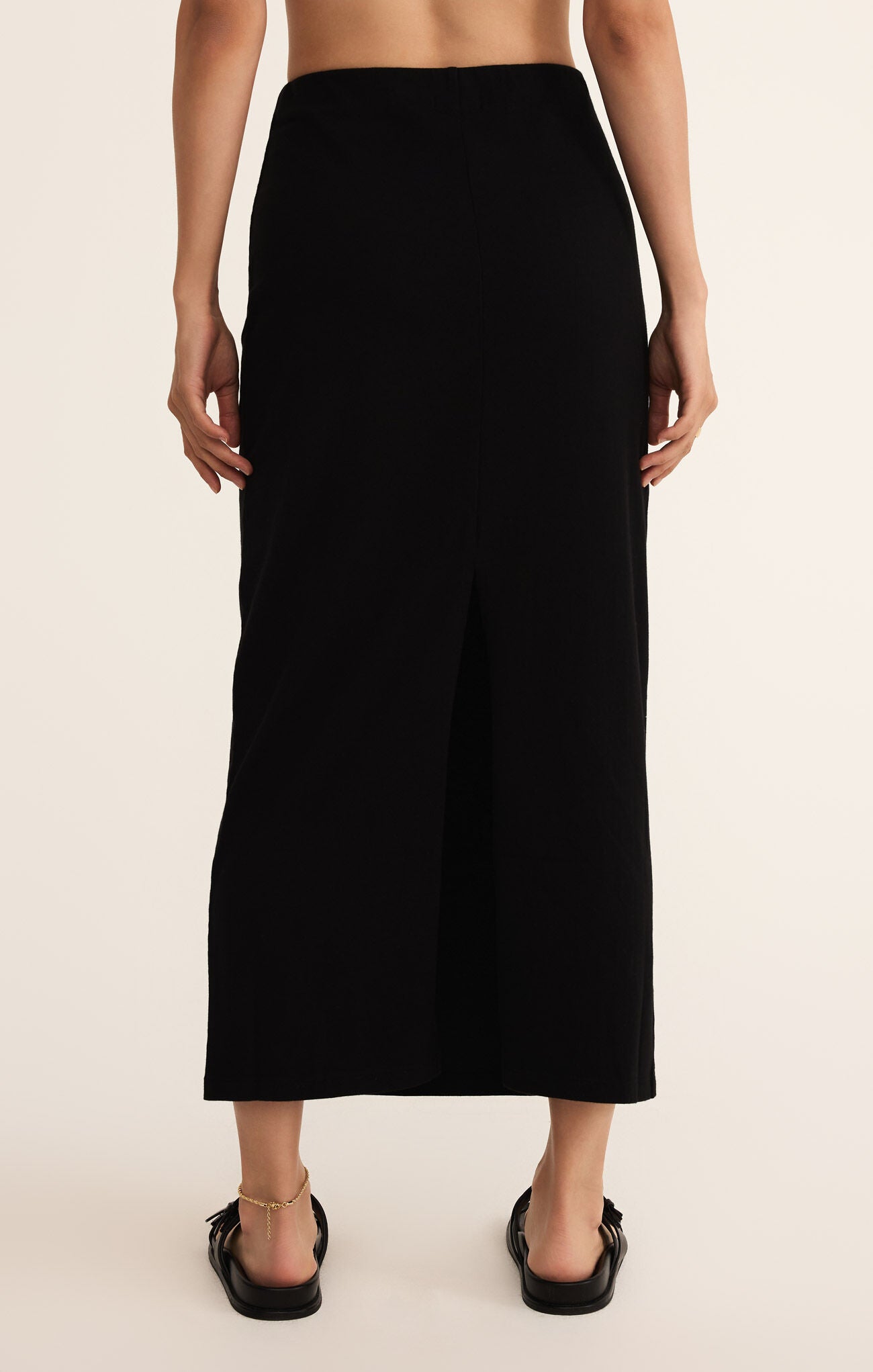 Model wearing ZSupply - Gail Midi Skirt in True Black - back.