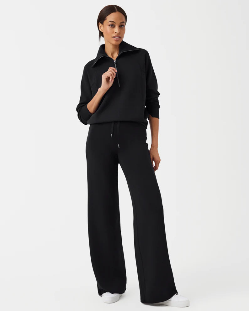 Model wearing Spanx - Air Essentials Wide Leg Pant in Very Black.