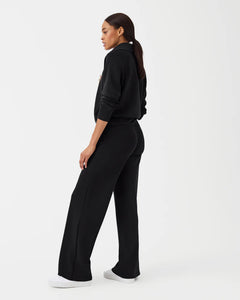 Model wearing Spanx - Air Essentials Wide Leg Pant in Very Black.