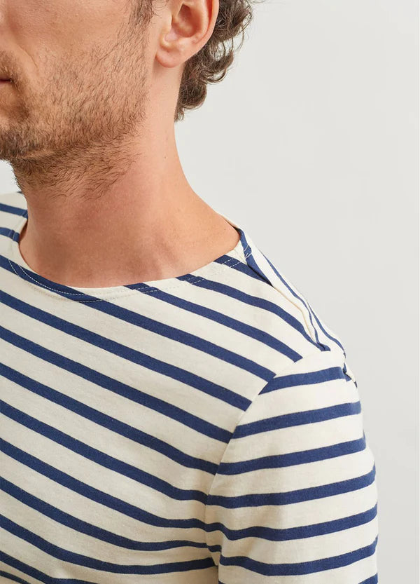 Model wearing Saint James - Minquiers Modern Men's Striped Sailor Shirt in Ecru/Marine.