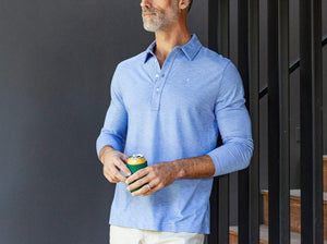 Model wearing Criquet - Brrr Long Sleeve Range Polo in Lapis Blue.