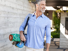 Load image into Gallery viewer, Model wearing Criquet - Brrr Long Sleeve Range Polo in Lapis Blue.
