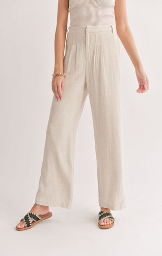 Model wearing Sadie & Sage - La Luna Pleated Trousers in Oatmeal.
