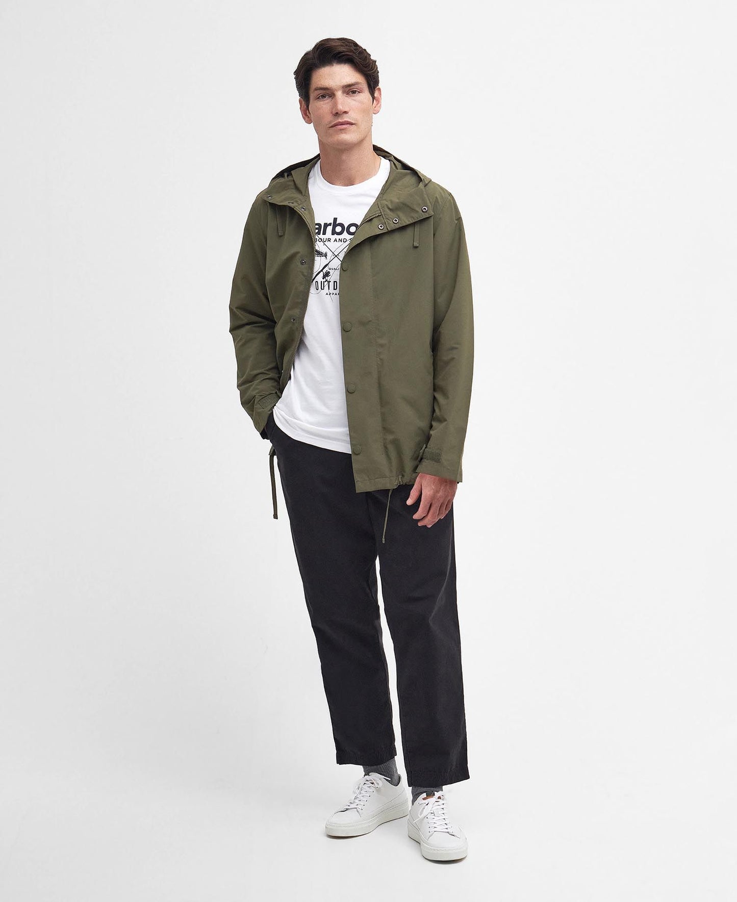 Model wearing Barbour Quay Showerproof Jacket in Olive.