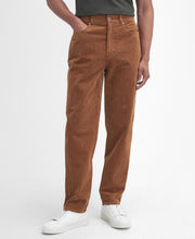 Load image into Gallery viewer, Model wearing Barbour Stretch Cord Trouser in Dark Honey.
