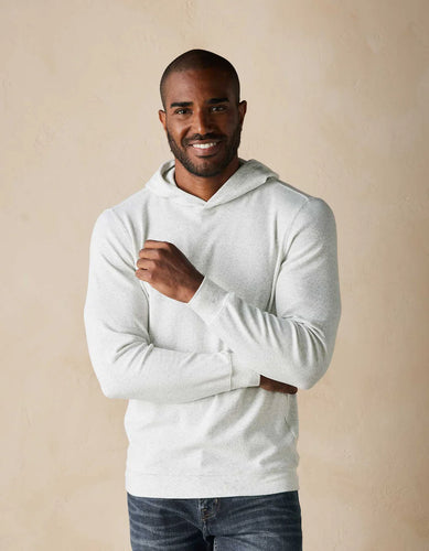 Model wearing The Normal Brand - Puremeso Essential Hoodie in Stone.