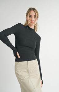 Model wearing Sadie &amp; Sage Ronan Mock Neck Knit Top in Dark Black.