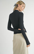 Load image into Gallery viewer, Model wearing Sadie &amp; Sage Ronan Mock Neck Knit Top in Dark Black - back.
