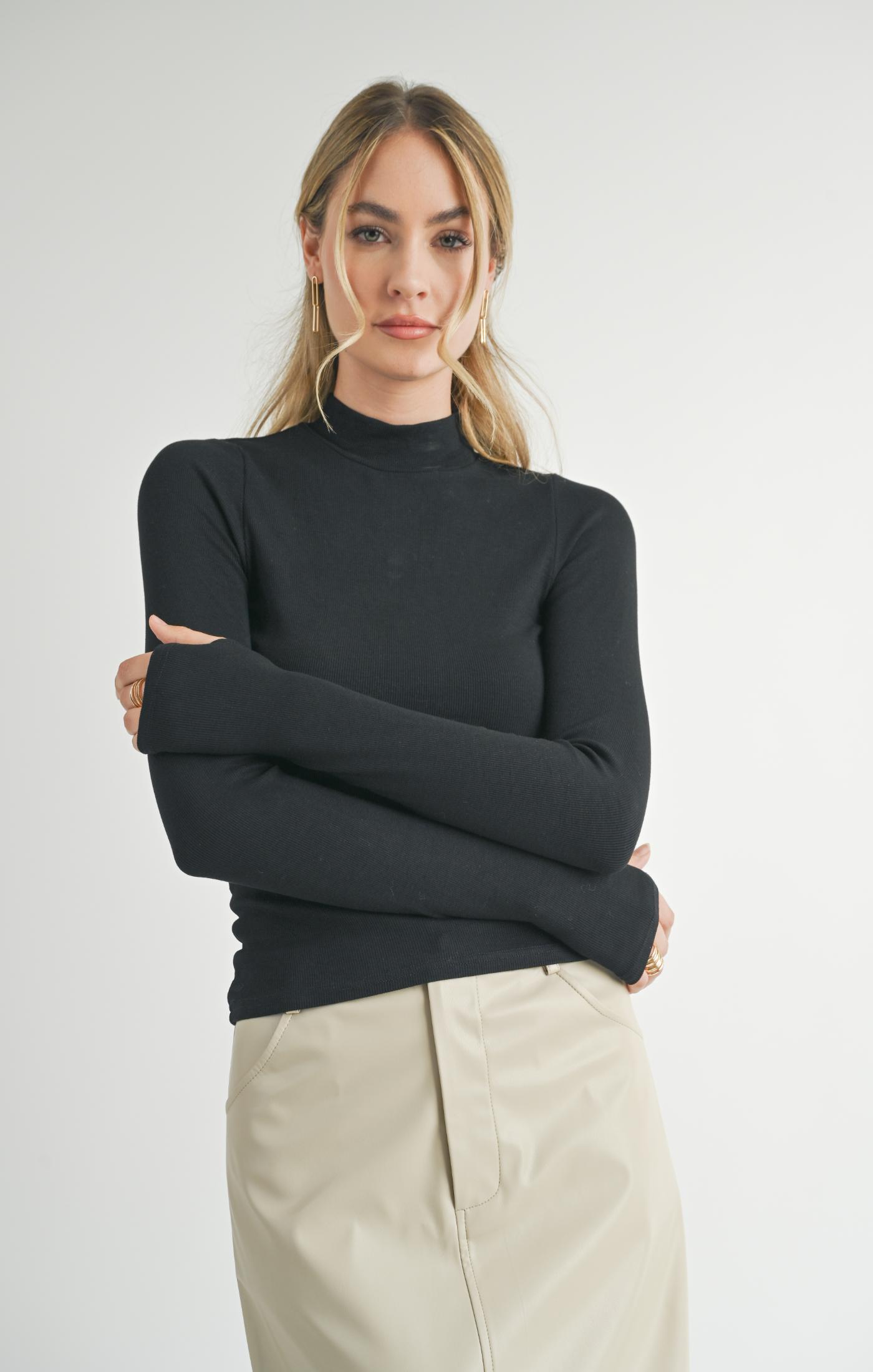 Model wearing Sadie &amp; Sage Ronan Mock Neck Knit Top in Dark Black.
