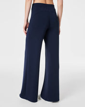 Load image into Gallery viewer, Model Wearing Spanx - Air Essentials Wide Leg Pant - Timeless Navy - back.
