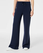 Load image into Gallery viewer, Model Wearing Spanx - Air Essentials Wide Leg Pant - Timeless Navy.
