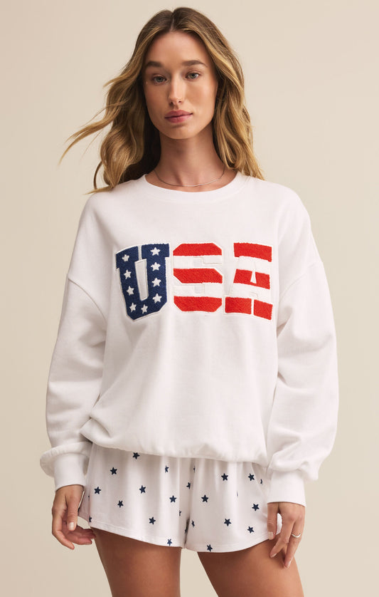 Model wearing ZSupply - Oversized USA Sweatshirt in White.