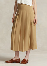 Load image into Gallery viewer, Model wearing Polo Ralph Lauren - Satin Pleated A-Line Midi Skirt in Camel.
