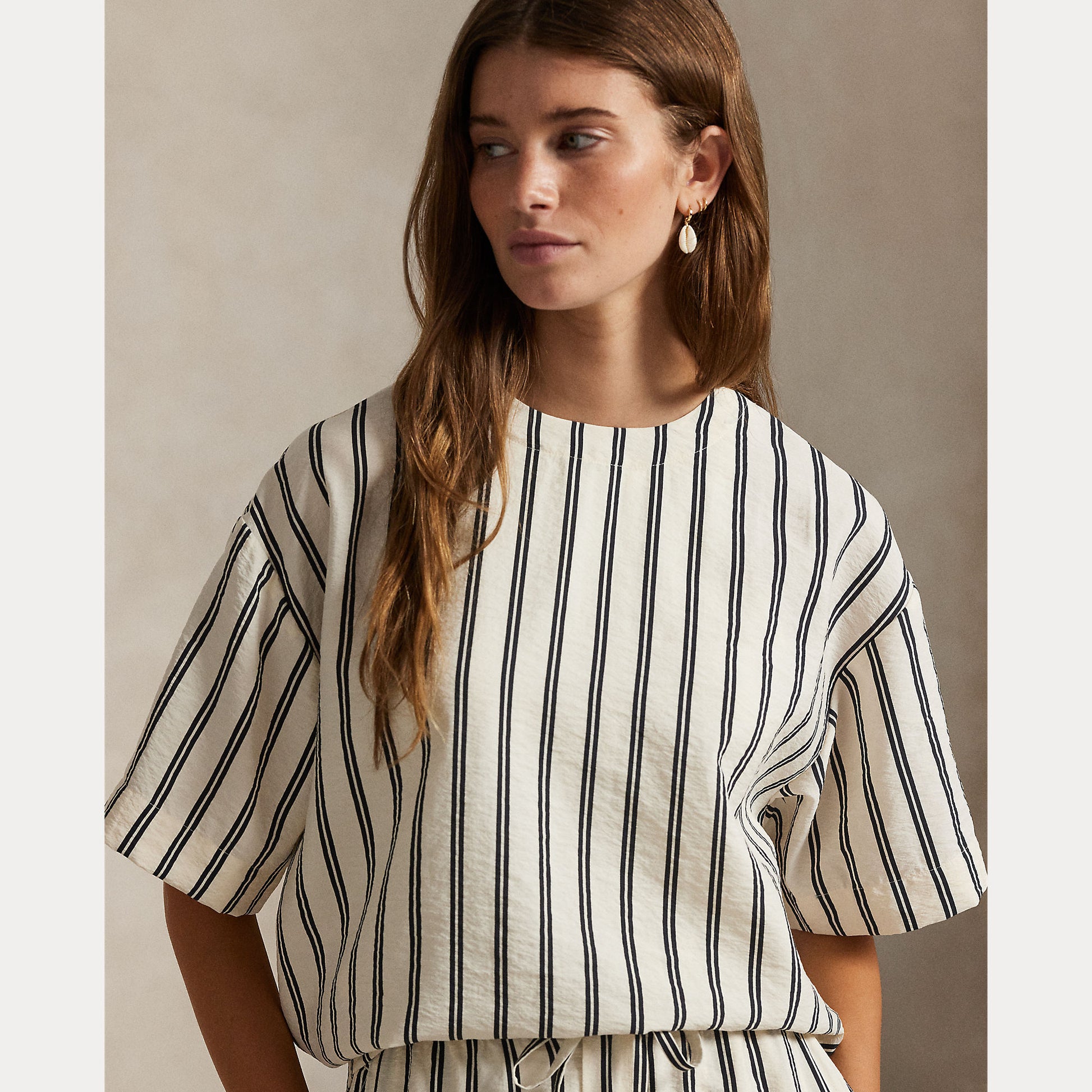 Model wearing Polo Ralph Lauren - Silk Nylon SS Crew Neck Blouse in White/Black Stripe.