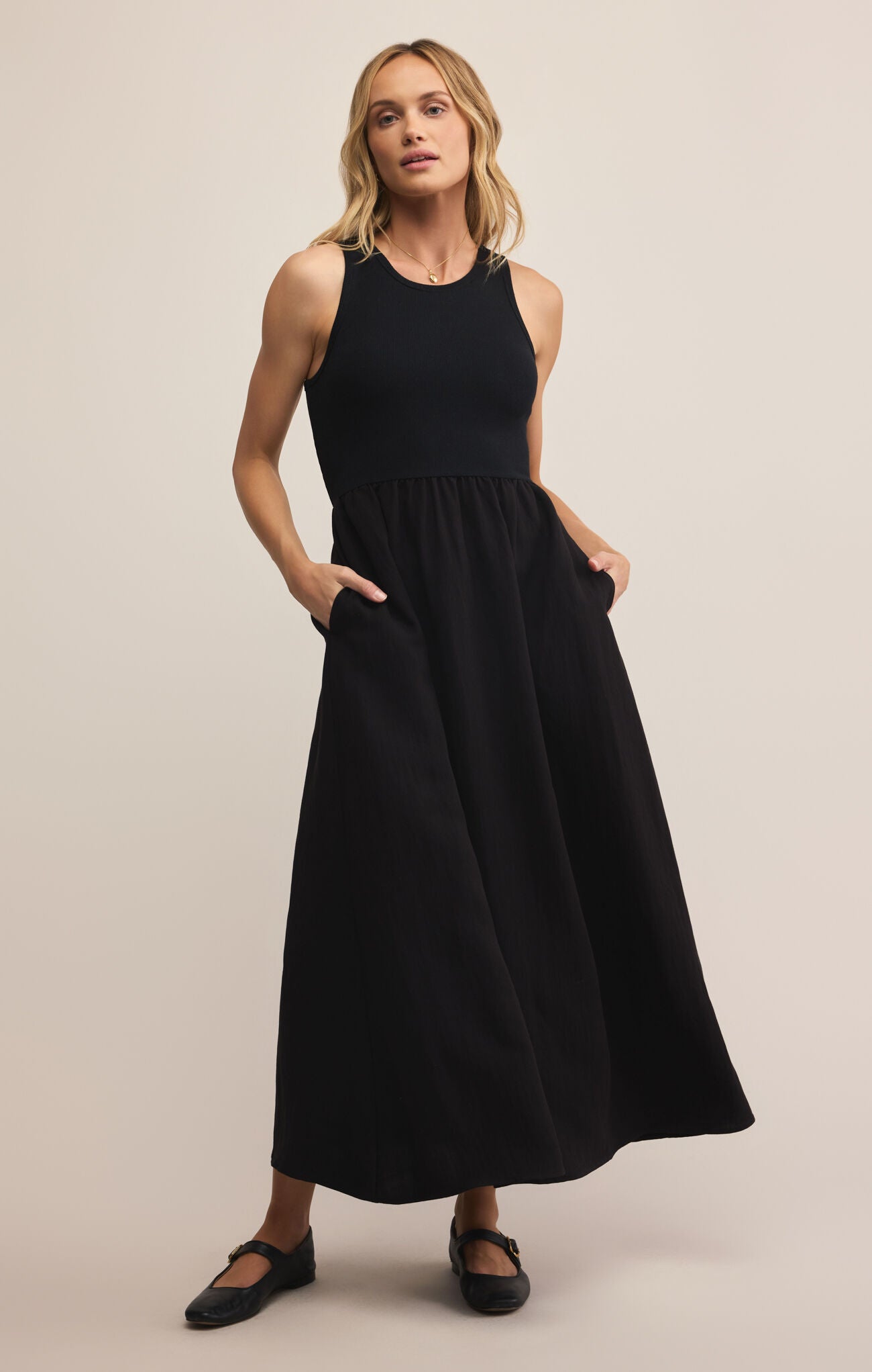 Model wearing ZSupply Charlotte Midi Dress in Black.