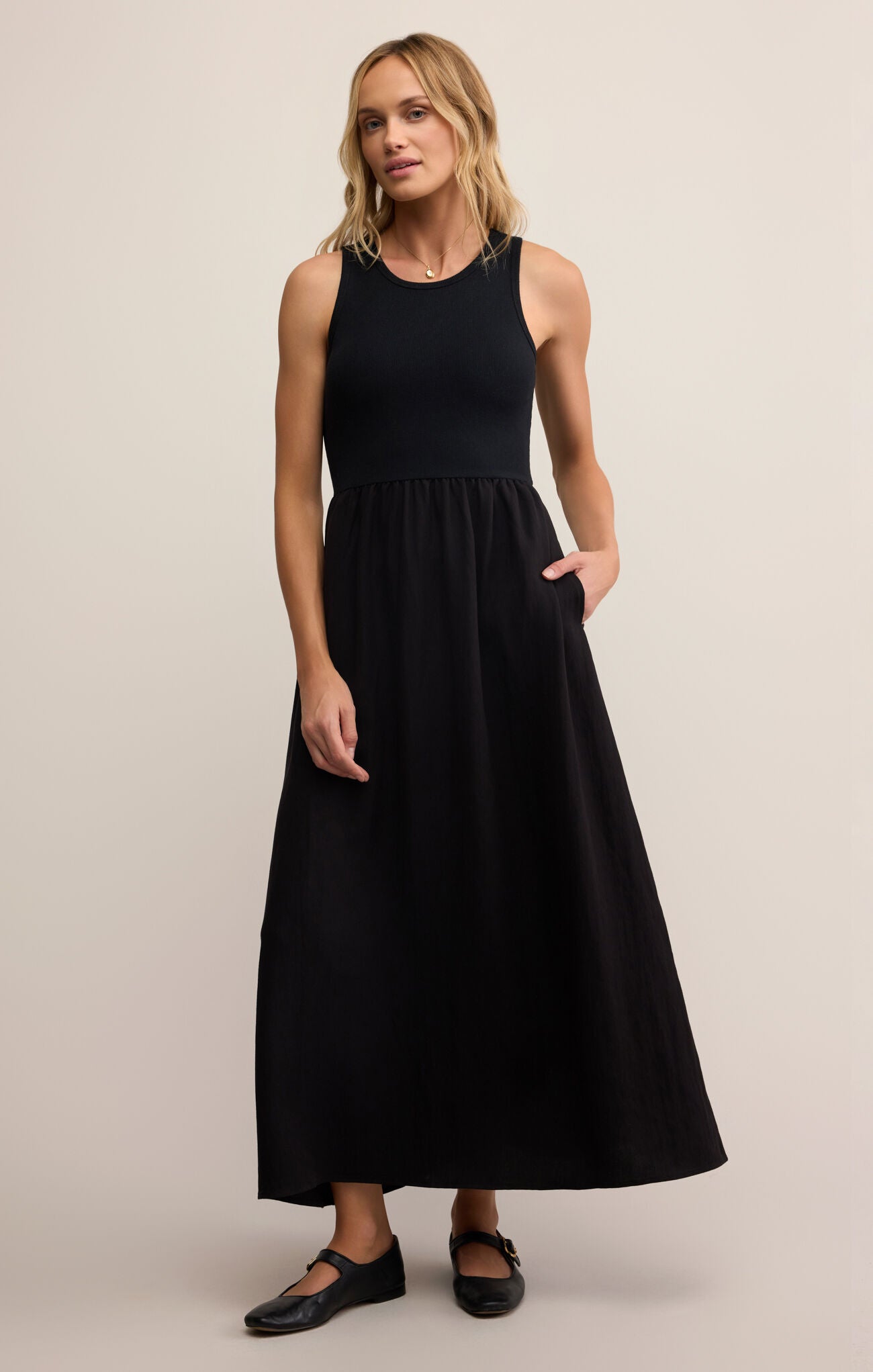 Model wearing ZSupply Charlotte Midi Dress in Black.