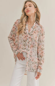 Model wearing Sadie & Sage - Dune Flowers Button Down Top in Ivory Apricot.