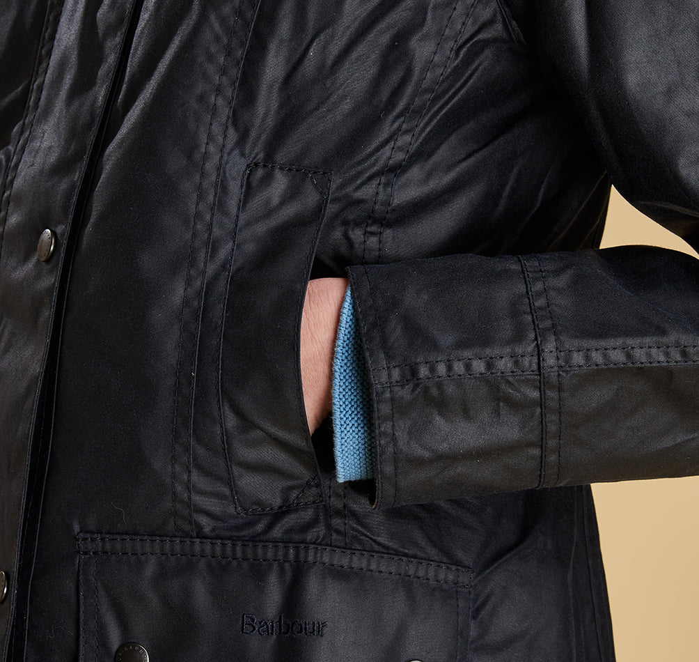 Model wearing Barbour Beadnell wax jacket in navy.