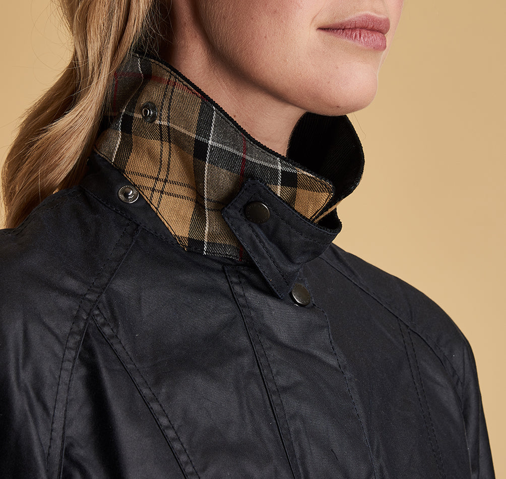 Model wearing Barbour Beadnell wax jacket in navy.