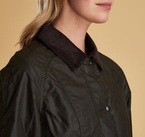Model wearing Barbour Beadnell wax jacket in olive.