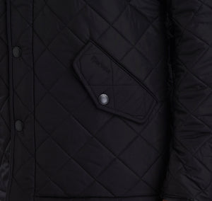 Pocket of Barbour Powell Quilt jacket in black.
