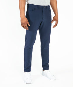 Model wearing Public Rec Workday Pant straight leg in navy.