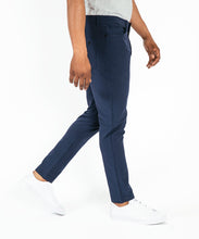 Load image into Gallery viewer, Model wearing Public Rec Workday Pant straight leg in navy.
