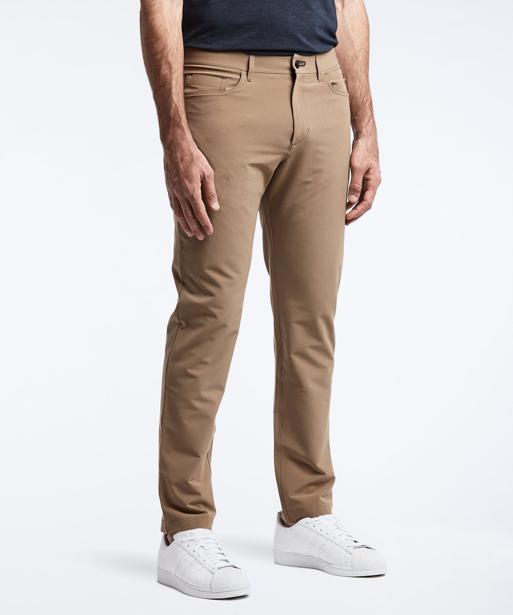 Model wearing Public Rec Workday Pant straight leg in dark khaki.