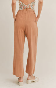 Model wearing Sadie & Sage - Out West Linen Pants in Tan.