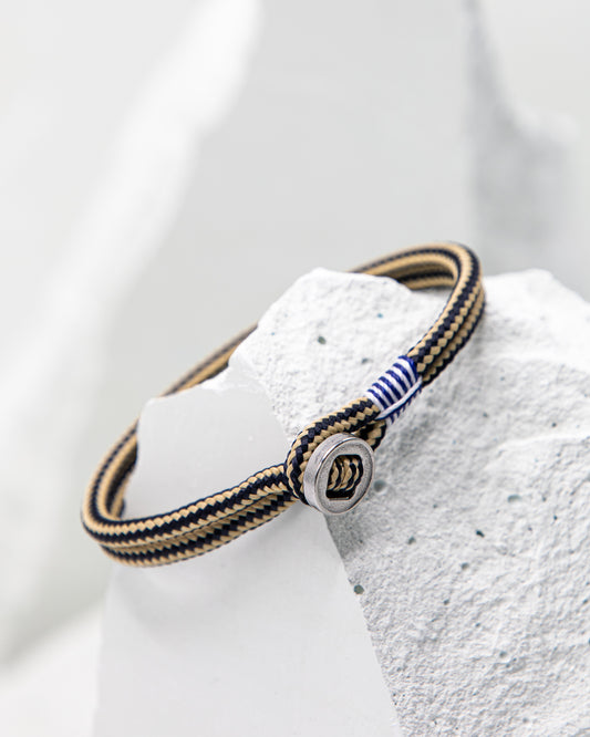 Pig & Hen Don Dino bracelet in navy / sand with silver ring.
