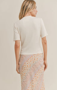 Model wearing Sadie & Sage - Seashell Mock Neck Top in Ivory - back.