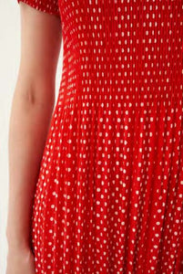 Model wearing Leo & Ugo - Leaf Print Pleat Dress in Red/White.
